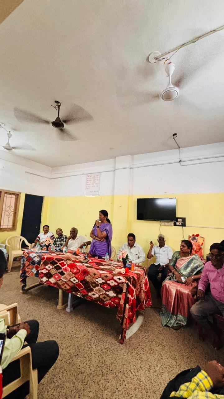 Senior member addressing the monthly meeting